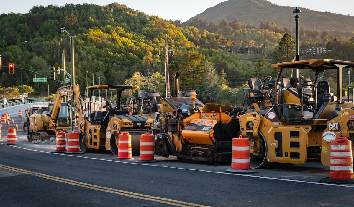 a group of backhoes on the road