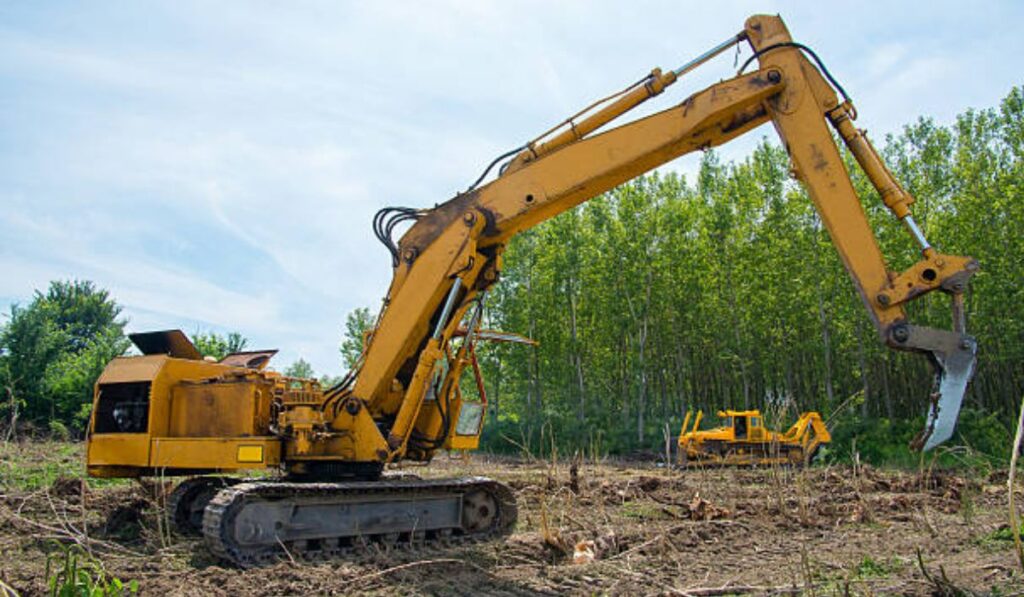 a large backhoe working on a land clearing project