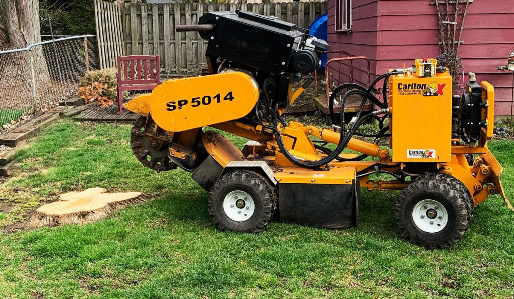a stump grinder with a tree stump beside it